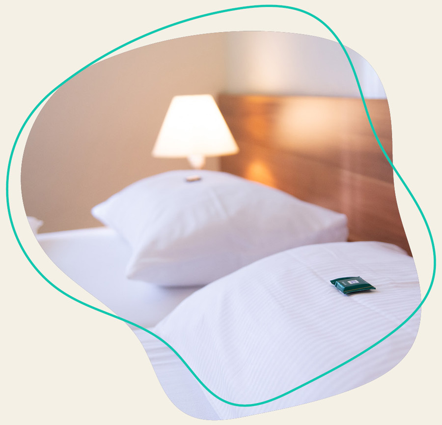 Das Bett vom einem Zimmer beim WDL Dünenhof 