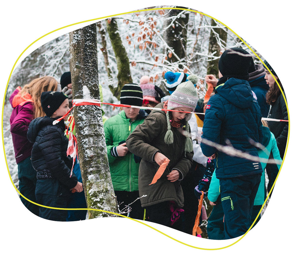 Kinder spielen im Winter im Wald